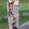 Lightning strike damage to brick casing of chimney. Flue liners were also damaged.